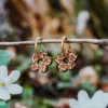 Boucles d’oreilles en bois Daisy, forme fleur avec motifs cœurs gravés, bijou printanier fabriqué en Suisse